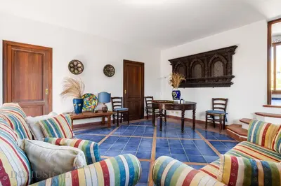 a living room with two couches and a table at Mille e Una Notte By Domus Sicily in Mondello