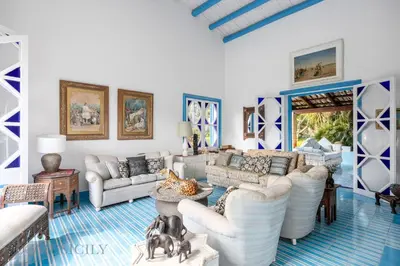 a living room with white furniture and blue floors at Mille e Una Notte By Domus Sicily in Mondello