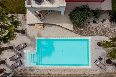an overhead view of a swimming pool in a yard at Villa Jacqueline con piscina privata 8 posti letto in Scopello