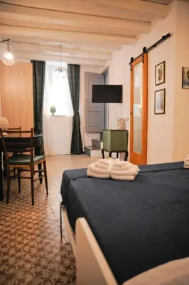 a bedroom with a bed with two towels on it at 4 Canti Central Loft & Ground floor in Palermo