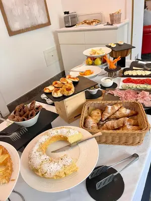 a table with many different types of bread and pastries at 4 Canti Central Loft & Ground floor in Palermo