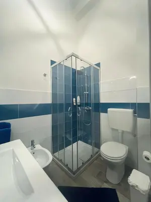 a bathroom with a shower and a toilet and a sink at Silvia's House in Castellammare del Golfo