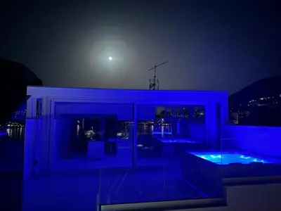 a house with a blue lit room at night at Attico sul Mare - Suite & Spa in Palermo
