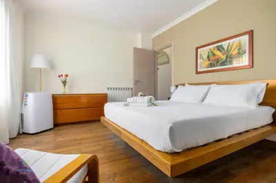 a bedroom with a large white bed in a room at Verosicily Villa Barcellona in Terrasini