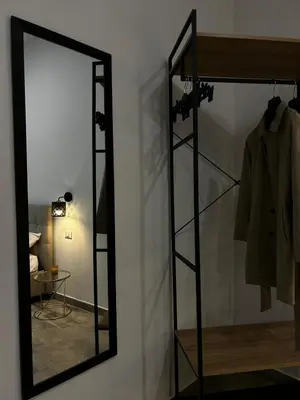 a mirror on a wall next to a room at Maquè apartments in Palermo