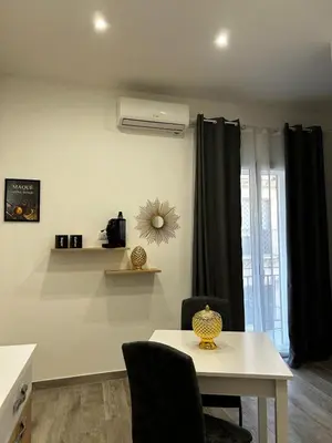 a living room with a table and a window at Maquè apartments in Palermo