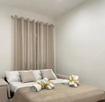 a bedroom with a bed with towels on it at Maquè apartments in Palermo