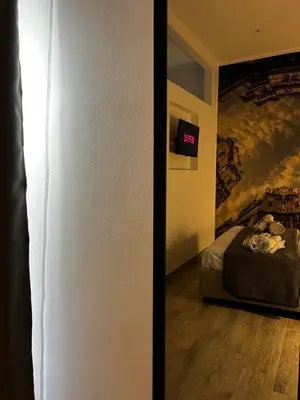 a bedroom with a bed with a clock on the wall at Maquè apartments in Palermo