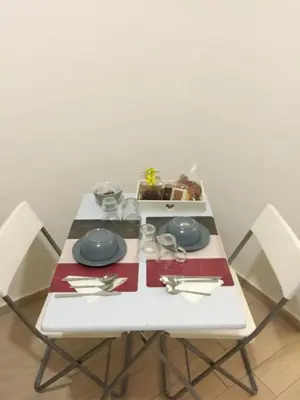 a white table with a plate of food on it at Vacanze Palermitane in Palermo