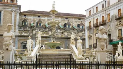 a fountain in front of a building with statues at Vacanze Palermitane in Palermo