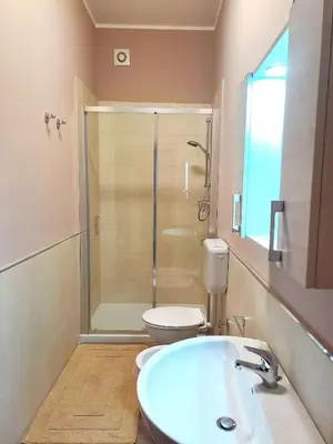 a bathroom with a shower and a sink and a toilet at La Finestra sul Golfo in Castellammare del Golfo