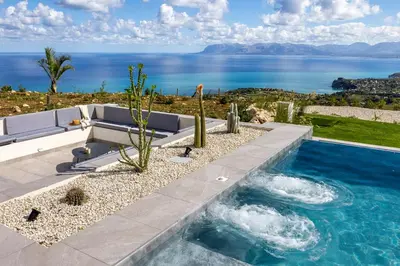 a swimming pool with a view of the ocean at Villa Adler Nature&Relax in Scopello