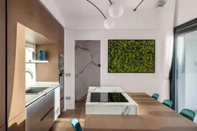 a dining room with a table and a green wall at Villa Adler Nature&Relax in Scopello