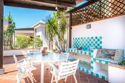 a patio with a table and chairs on a house at Villetta Milù in Palermo