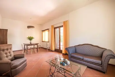a living room with a couch and a table at Villetta Milù in Palermo