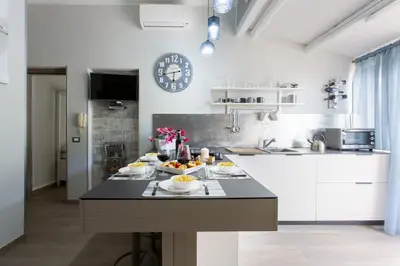 a kitchen with a table with food on it at A 2 passi dal castello ,appartamento con veranda in Castellammare del Golfo