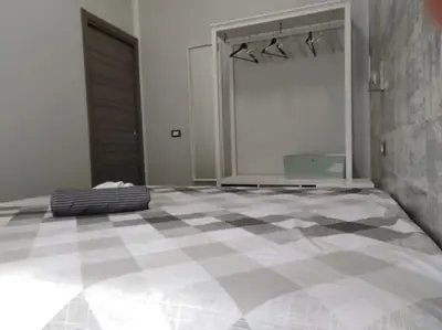 a bedroom with a checkered floor with a large bed at A 2 passi dal castello ,appartamento con veranda in Castellammare del Golfo