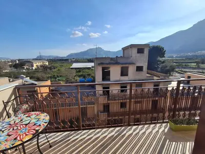 a bed and a couch in a room at Ricky House in Palermo