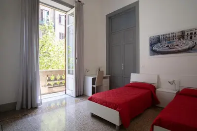 a bedroom with two beds and a large window at ROME 118 intero appartamento in Palermo