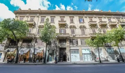 a sidewalk outside of a building with a door at ROME 118 intero appartamento in Palermo