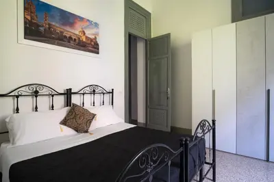 a bedroom with a large bed with a black frame at ROME 118 intero appartamento in Palermo