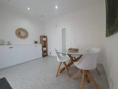 a dining room with a table and two white chairs at Private House 14 Palermo in Palermo