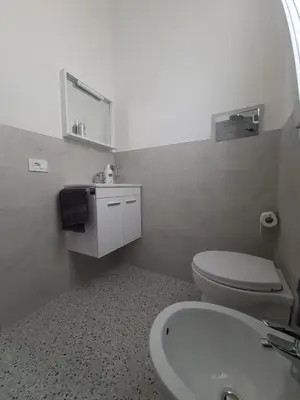a bathroom with a white toilet and a sink at Private House 14 Palermo in Palermo