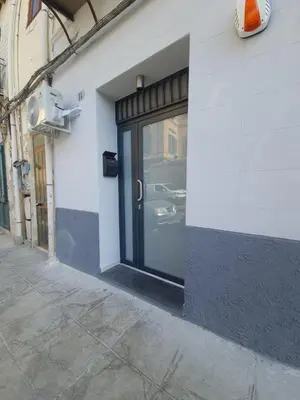 a door to a building with a car in it at Private House 14 Palermo in Palermo