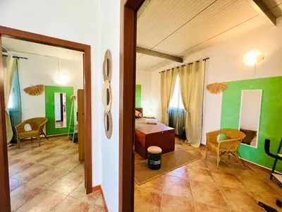 a room with green walls and a room with a table at Tri Ri Coppe in Cinisi