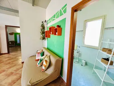 a room with a couch and a green wall at Tri Ri Coppe in Cinisi