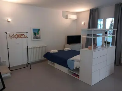 a small bedroom with a bed and a television at Villa Costa Mondello in Palermo