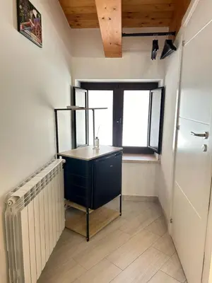 a kitchen with a black cabinet and a window at Calatafimi Rocca Home in Palermo