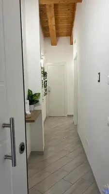 a hallway with white walls and a wooden ceiling at Calatafimi Rocca Home in Palermo
