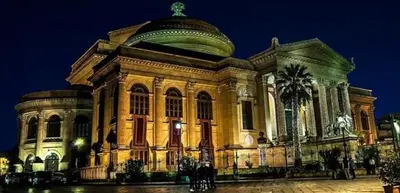 a large building with a dome on top at night at La casetta di gra in Palermo