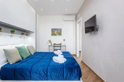 a bedroom with a blue bed with a teddy bear on it at Sant'Erasmo luxury home in Palermo