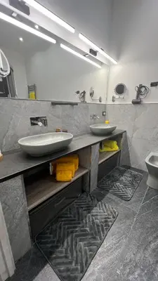 a bathroom with two sinks and a large mirror at A Casuzza in Palermo