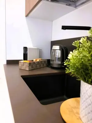 a kitchen counter with a coffee maker on it at Lily Suite 10 in Palermo