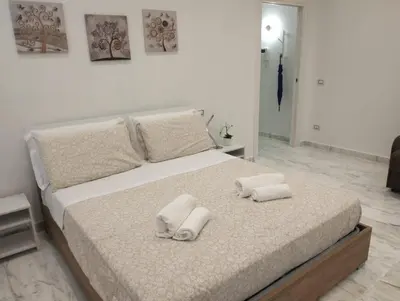 a bedroom with a bed with two towels on it at Lily Suite 10 in Palermo