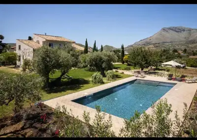 a large swimming pool in front of a house at VILLA AZUL in Castellammare del Golfo