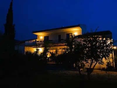 a building lit up at night with lights at VILLA AZUL in Castellammare del Golfo