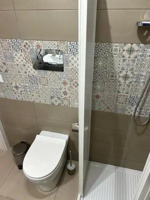 a small bathroom with a toilet and a shower at La Cupola - casa vacanze n 10 in Termini Imerese