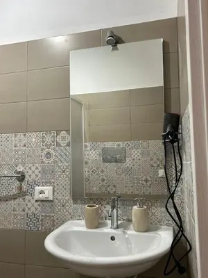 a bathroom with a sink and a mirror at La Cupola - casa vacanze n 10 in Termini Imerese