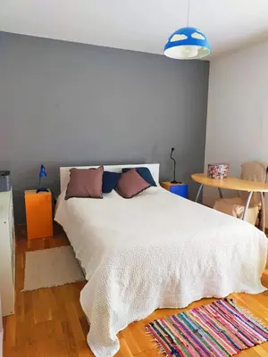 a bedroom with a white bed and a table at Casa Anita In centro in Palermo