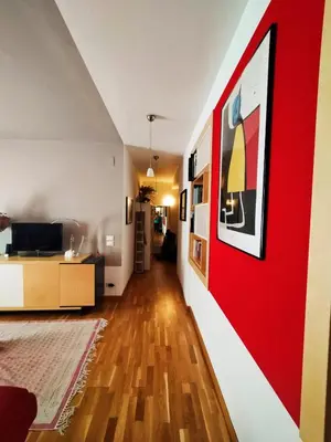 a living room with a red accent wall at Casa Anita In centro in Palermo