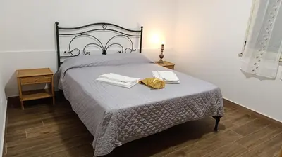 a bedroom with a bed with two towels on it at La Terrazza Bella Vista in Castellammare del Golfo