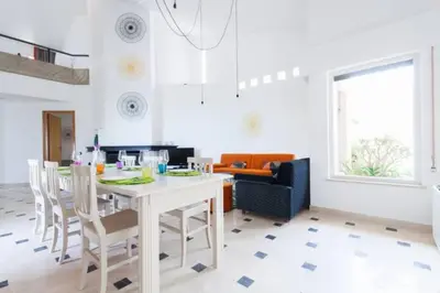 a living room with a white table and chairs at Villa delle Sterlizie con piscina e jacuzzi by Le Dhome Sicily in Partinico