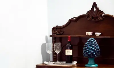 a bottle of wine and two glasses on a table at la Kalsa 14 nel centro storico di Palermo in Palermo