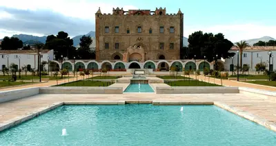 a building with a swimming pool in front of a building at Maison al-Aziz in Palermo