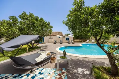 a swimming pool and a boat in a yard at Villa Celeste in Castellammare del Golfo