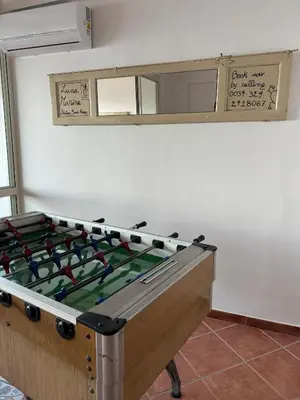 a large pool table in a room with a mirror at Luna Marina - Sicilian beach house in Santa Flavia